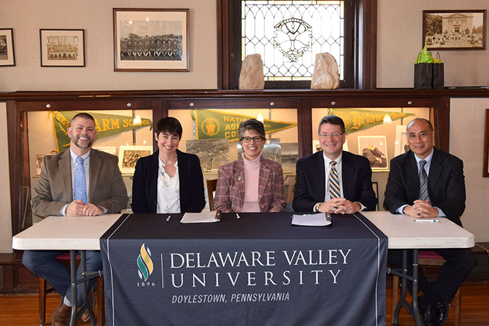 Representatives from Longwood Gardens and DelVal participate in a signing on campus