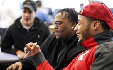 4 students looking at a computer