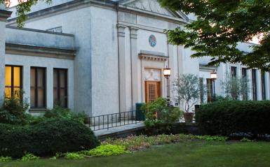 stately building at twilight surrounded by trees