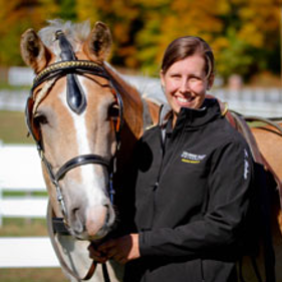 Department of Equine Science and Management Instructor Katie Kashner stands next to a horse. 