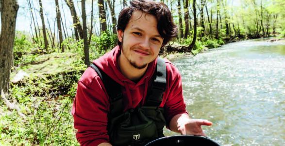 Jessie Edwards at Lake Archer with a bucket in his hand.