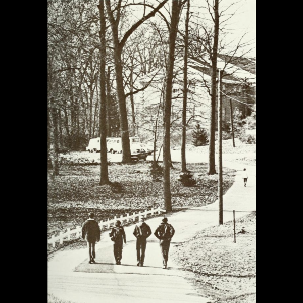 Students from 1970’s walking up a farm road