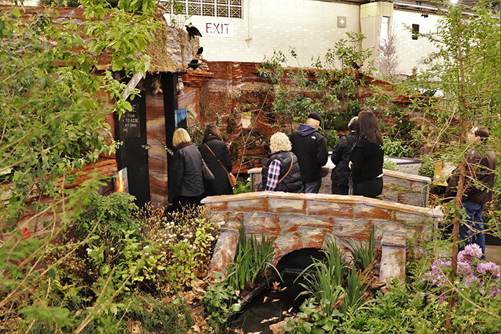Visitors walk through DelVal's Flower Show exhibit.