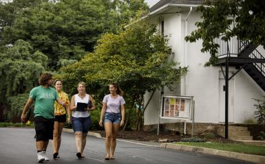 A prospective student and her family taking a tour with an admissions counselor