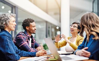 4 students working in a small group conference room