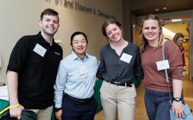 Four scholarship recipients pose for a group photo at the scholarship reception.