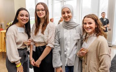 Four female DelVal students smile for a group photo at the scholarship reception. 