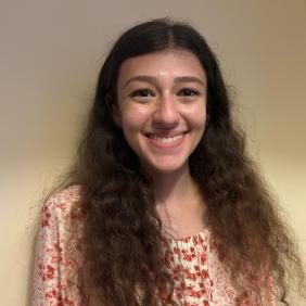 A headshot of Beth Portnoy against a white wall.