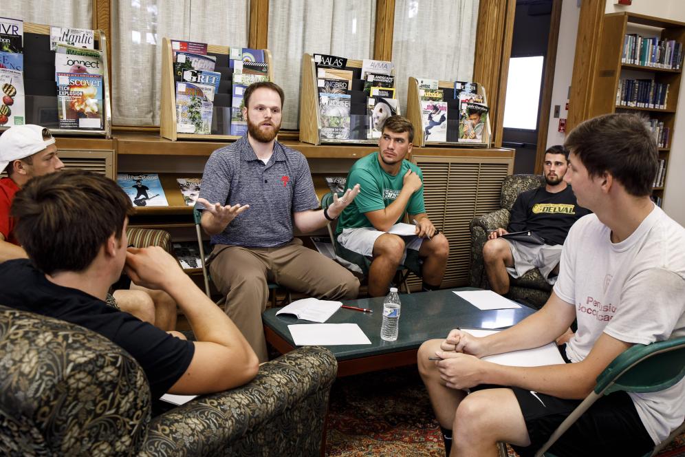 A guest speaker talks with a group of students in Delaware Valley University's library about how to stand out in job interviews.