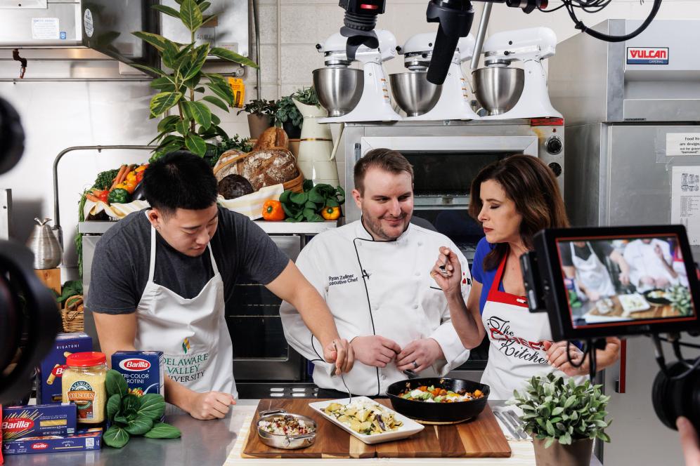 Nicholas Choi ’24, Ryan Zellner, General Manager at Metz Culinary Management, and Host Tina Marie Lavan taste testing the Sweet Potato and Chorizo Skillet
