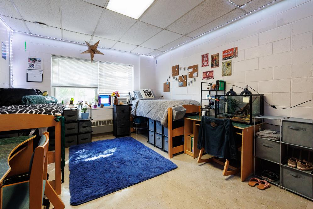 A typical dorm room set up with two beds and decorated by the students.