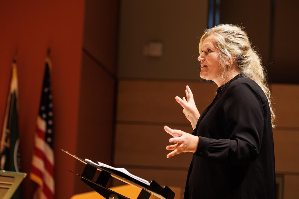 Professor Lauren Ryals is conducting the crowd.
