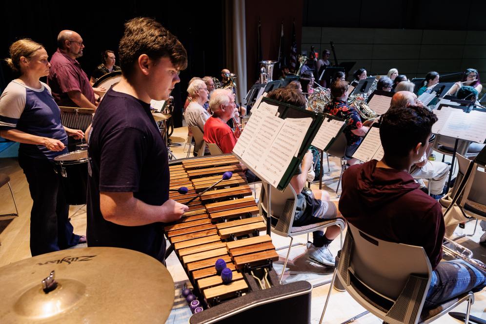 A side view of a student playing the xylephone. 