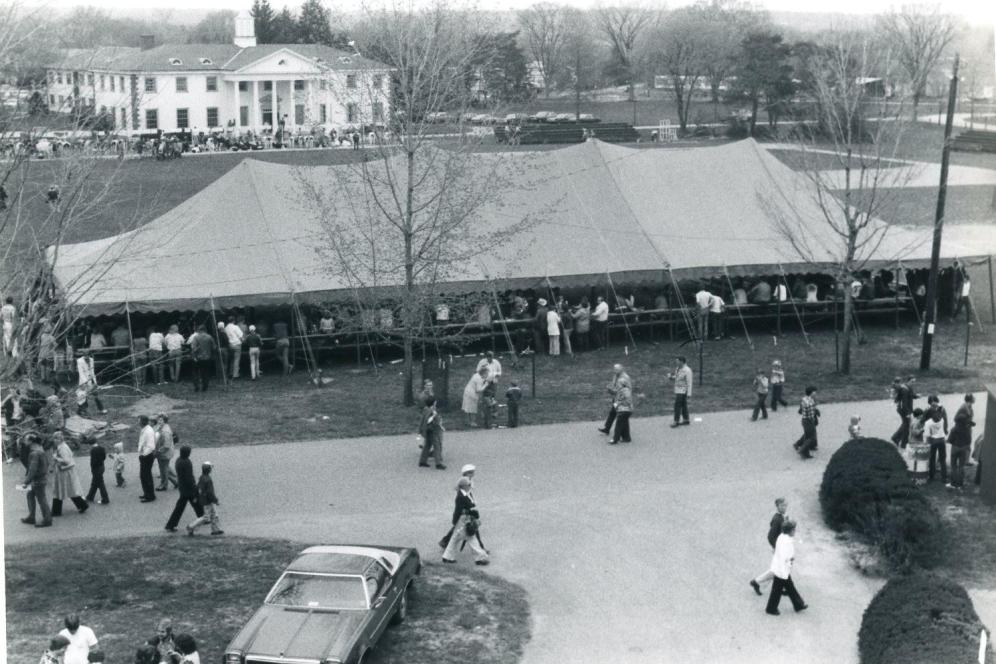An old black and white photo of the vendors at a-day