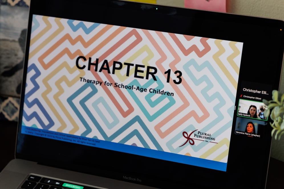 A speech-language pathology course presentation is photographed on a computer.