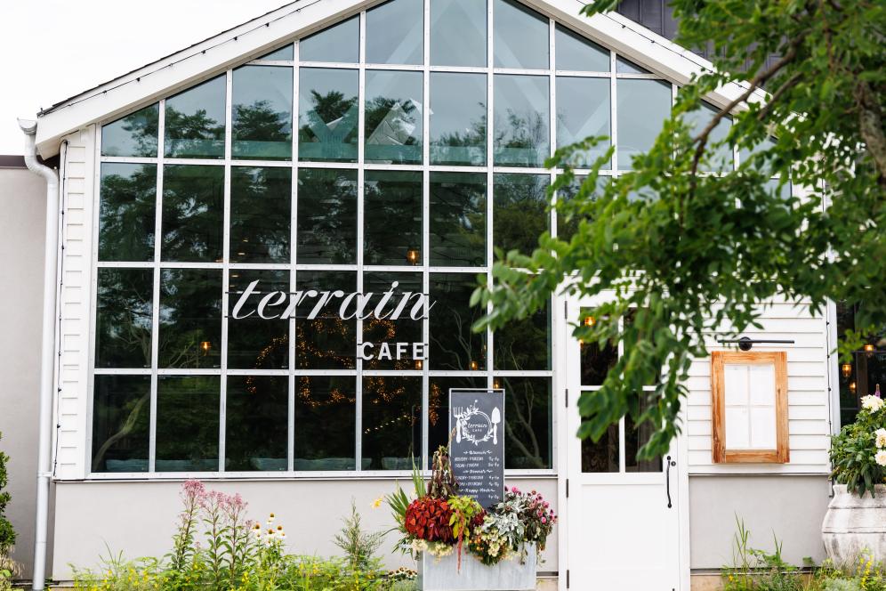 The outside window of Terrain Cafe with terrain signage.