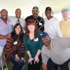 A group of alumni pose for a photo at the homecoming tent in 2013.