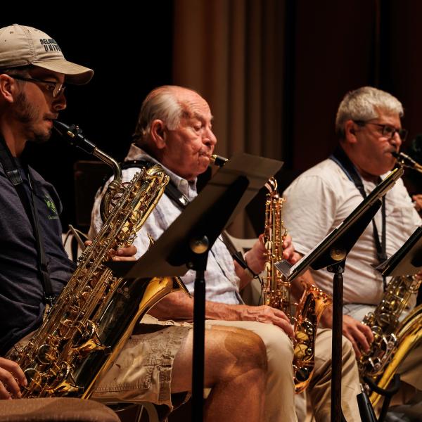 Three members of the summer jazz band playing on stage. 